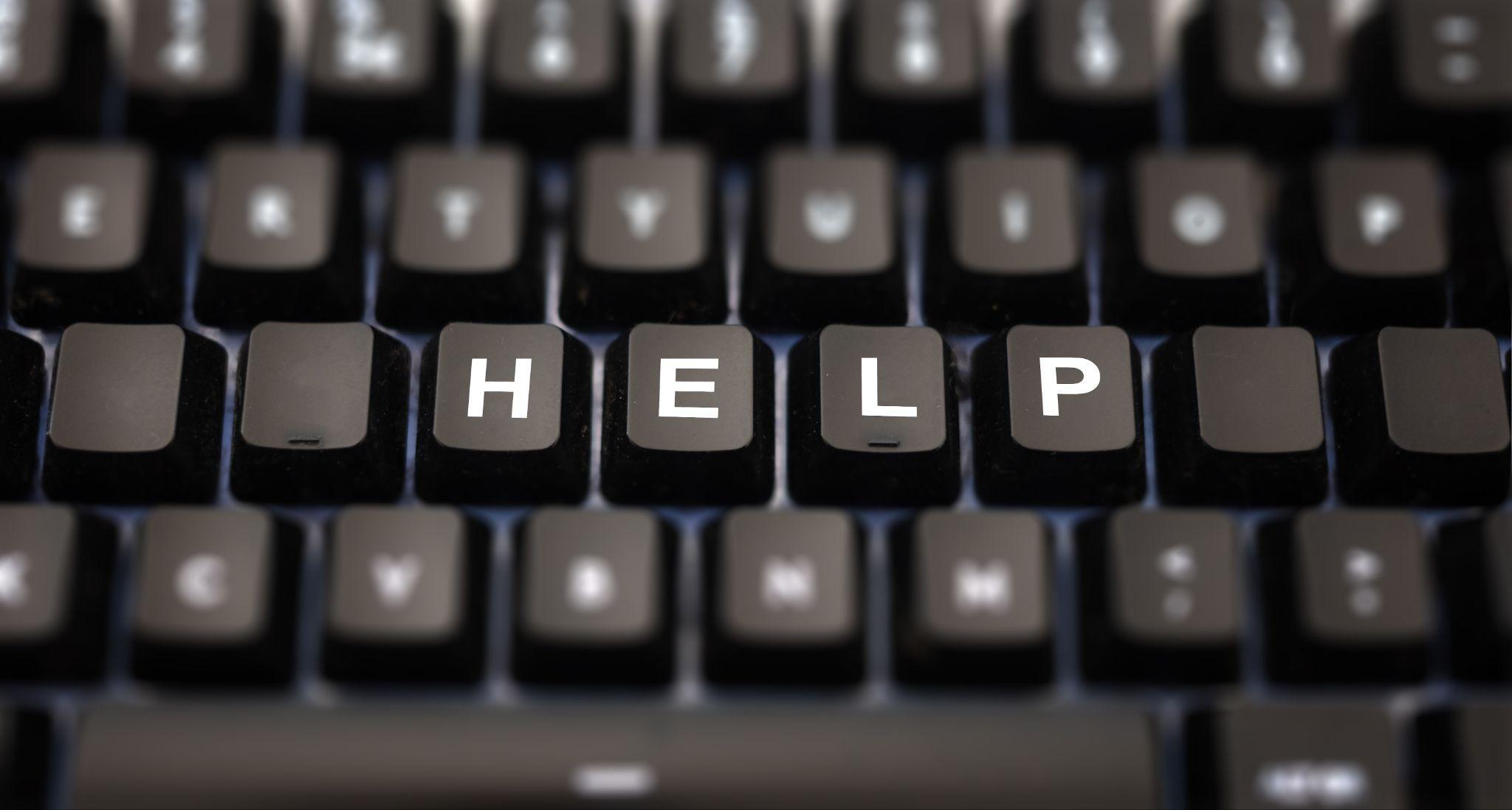 Close-up of a keyboard with custom keycaps showing HELP