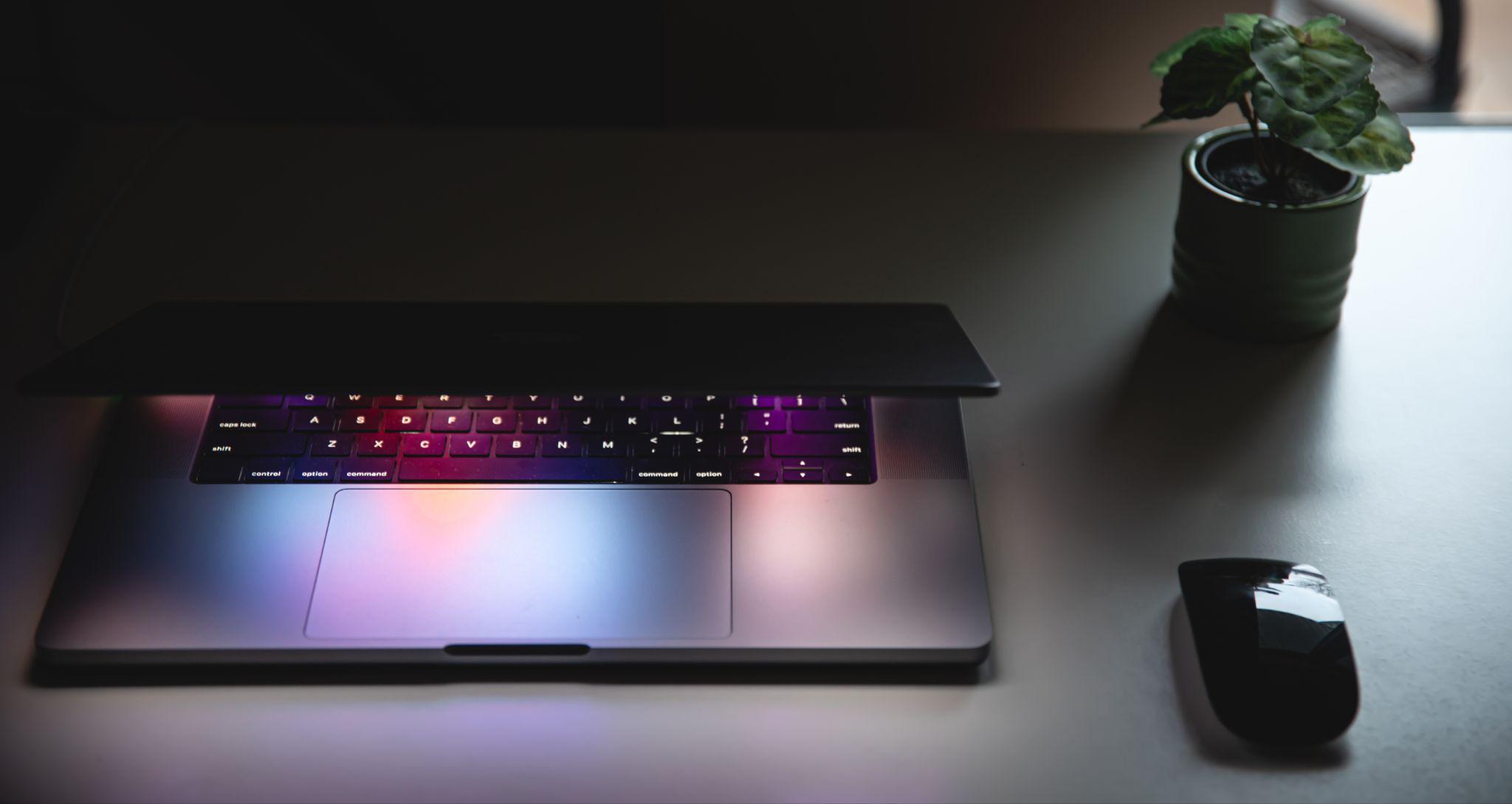 A laptop connected to a docking station on a desk