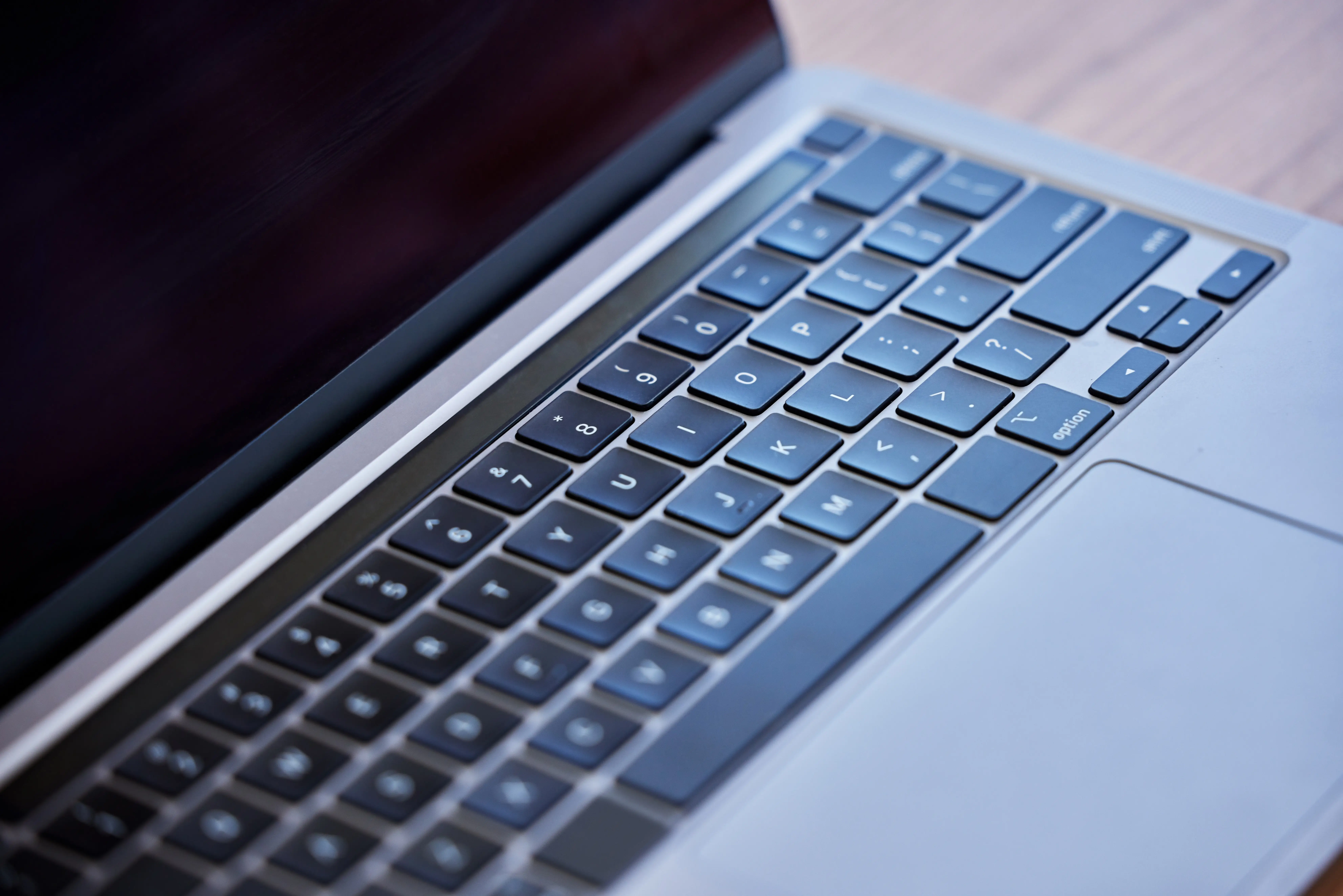 MacBook laptop open with focus on keyboard and Touch ID power button area